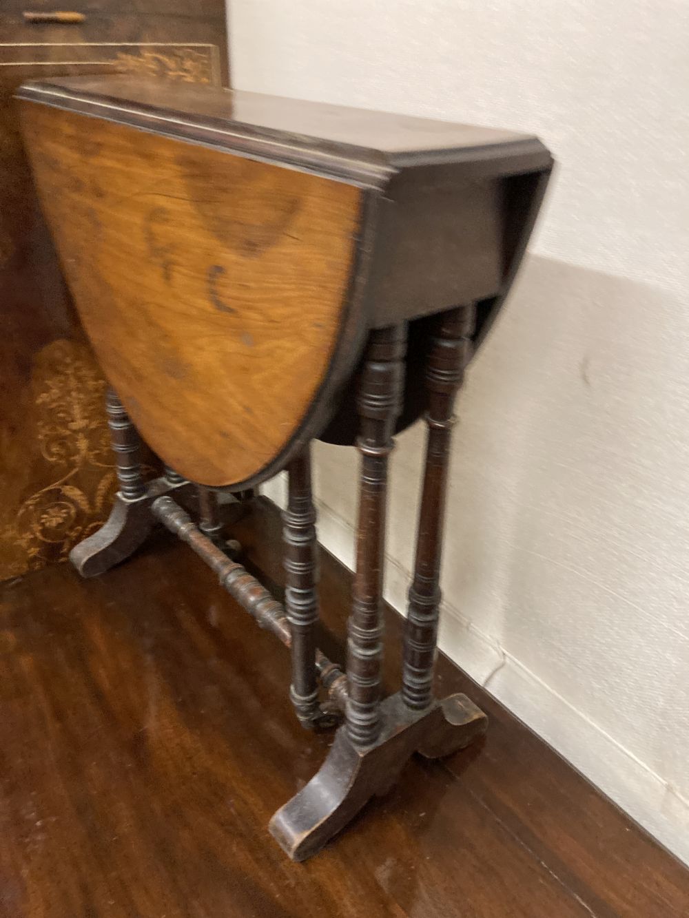 A late Victorian walnut Sutherland table, width 53cm height 56cm, together with a childs rush seat elbow chair